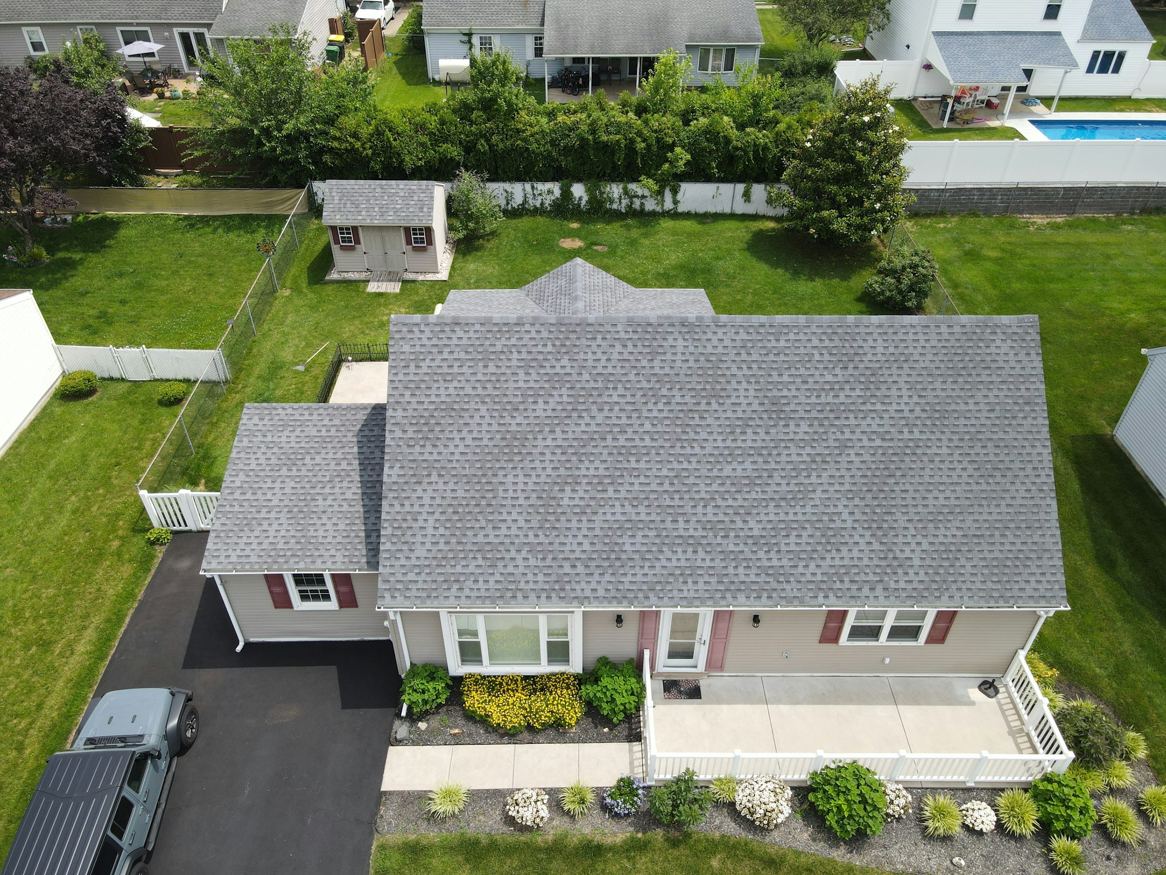 Aerial view of a home with a new grey asphalt shingle roof